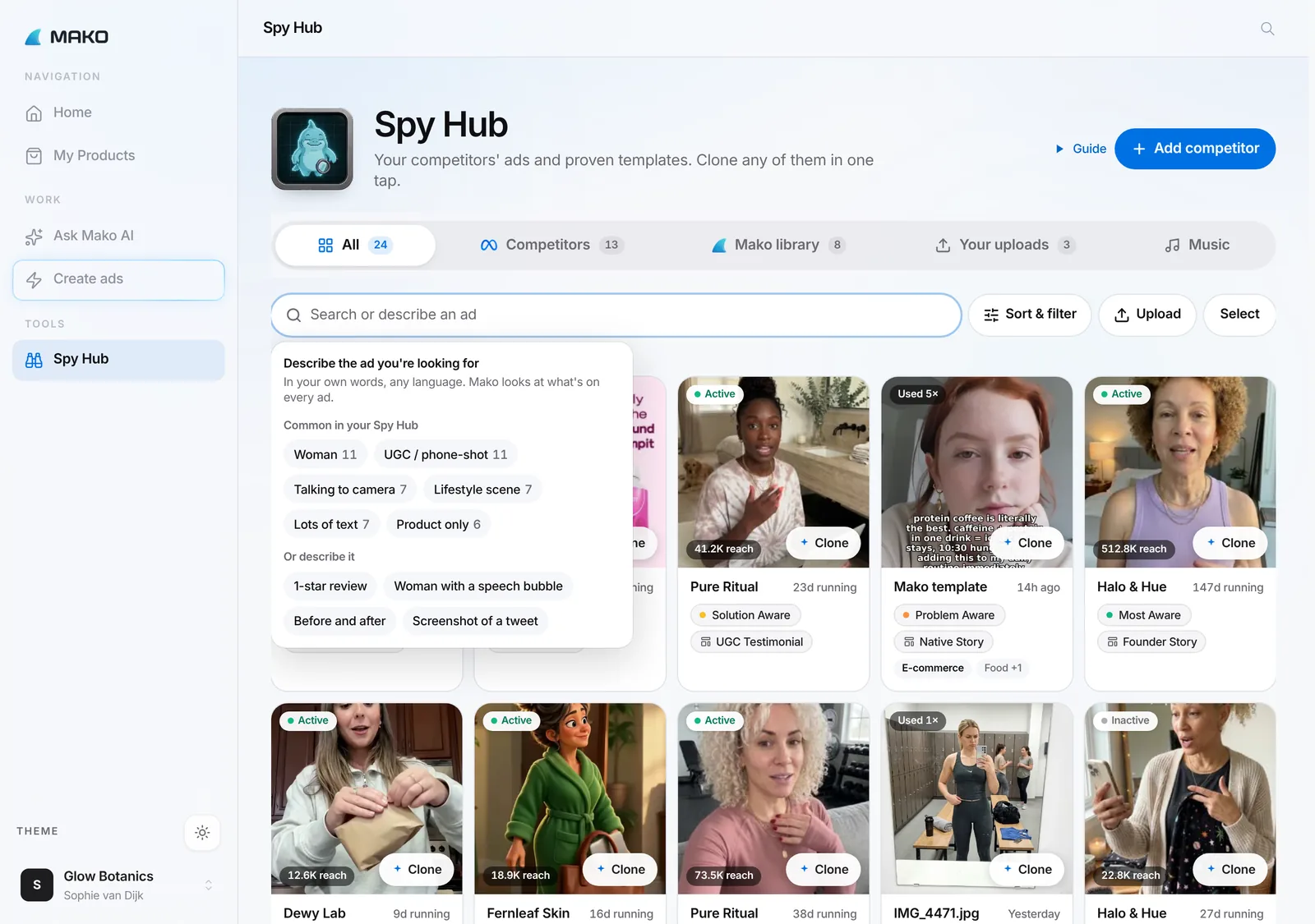 Spy Hub with the search box open: "Describe the ad you're looking for", common tags like Woman and Talking to camera, and examples like 1-star review